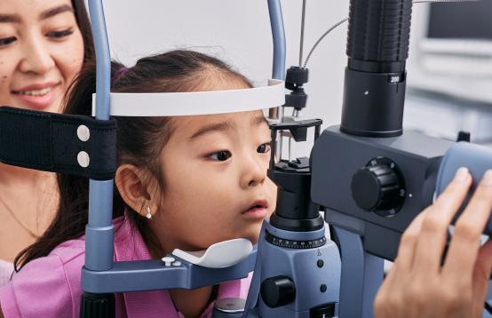 Young girl at the optometrist having her eyes tested.