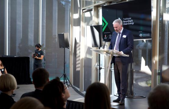 Image of a person speaking at a lectern