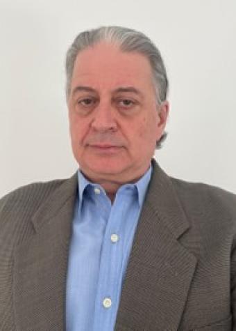 Peter Milic headshot of man with short grey hair wearing a light blue collared shirt and grey jacket.